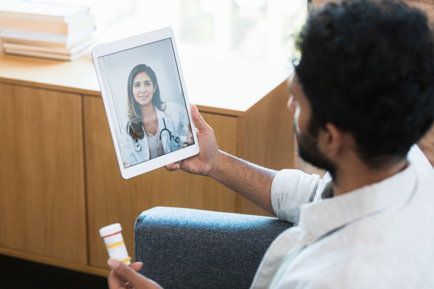 Man talks with doctor via telemedicine appointment